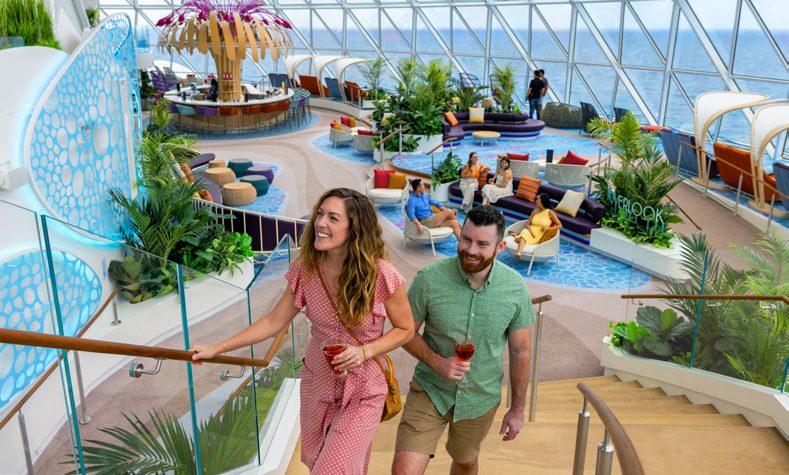 Guests walking through an open-air neighborhood aboard Icon of the Seas